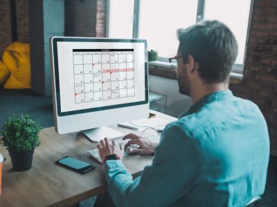 Nice smart man looking at the calendar